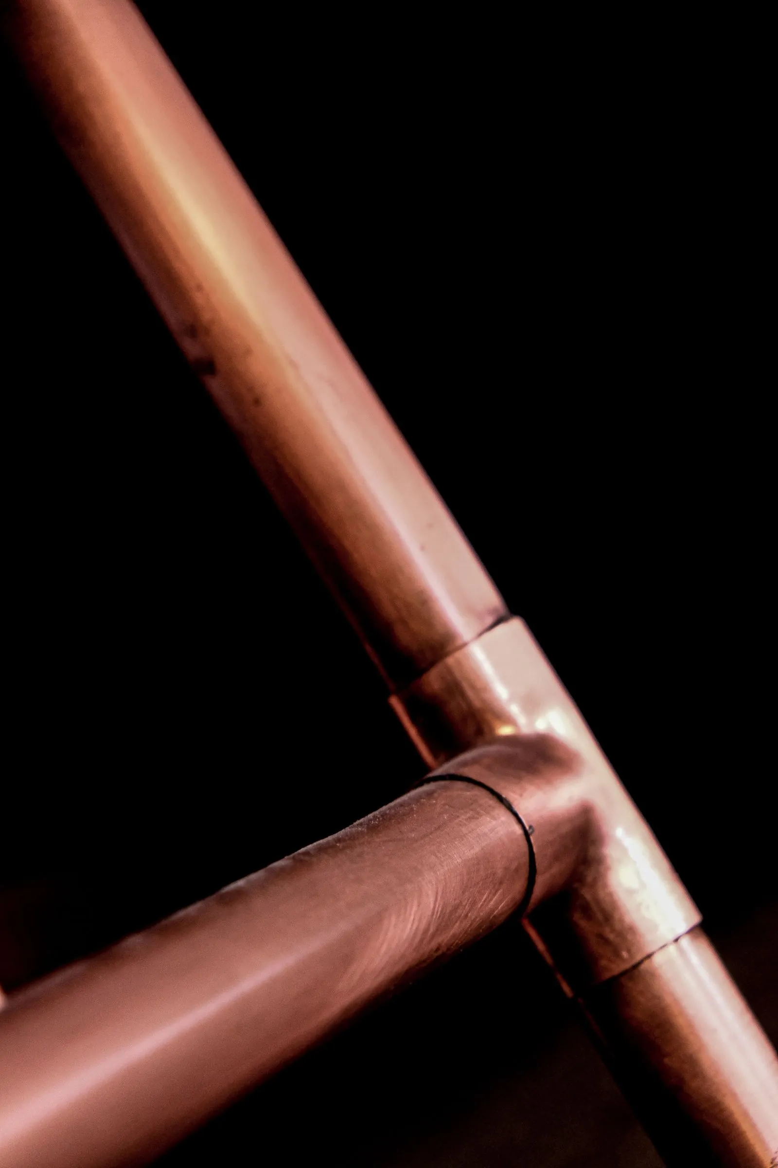 Plumber tightening a fixture connection with a wrench