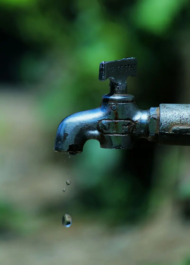Example: close-up of an old rusty faucet with water droplets falling