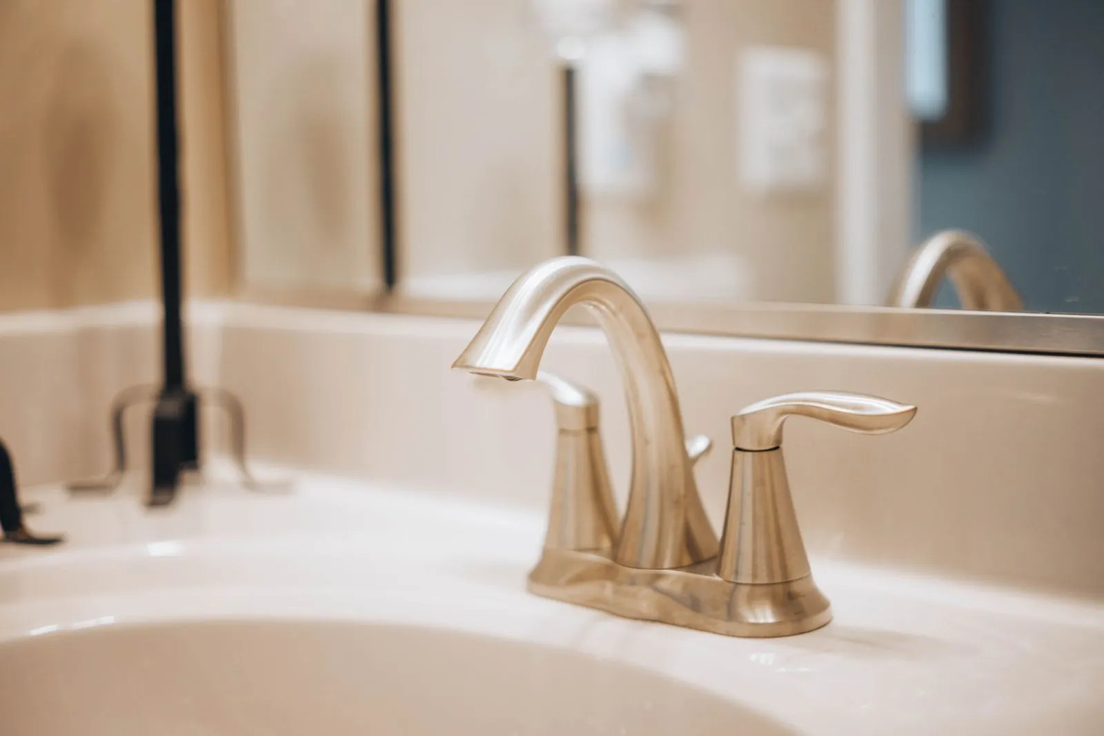 Example: modern stainless faucet on a white ceramic sink